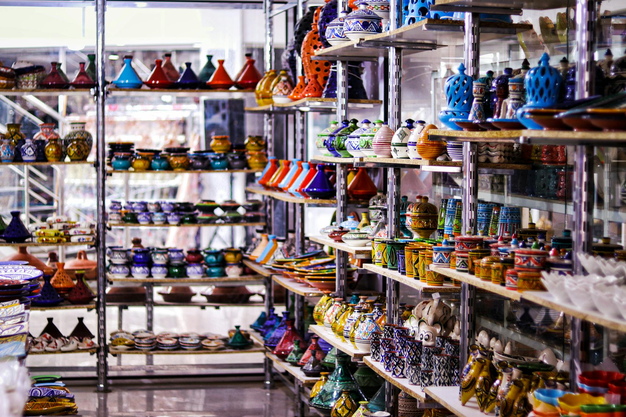 Explore vibrant Moroccan ceramics beautifully displayed in a traditional market setting.